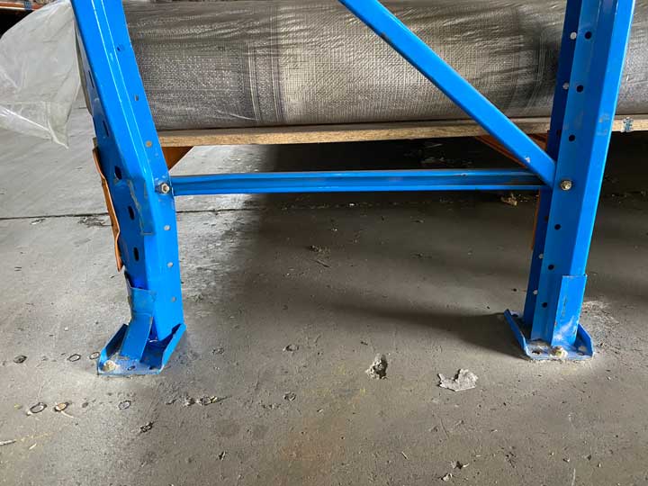 Bent upright frame in warehouse racking